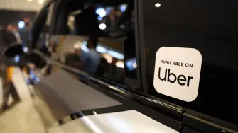 Lucid, Nuro, and Uber unveil a robotaxi during Nvidia Live at CES 2026 ahead of the annual Consumer Electronics Show in Las Vegas, Nevada, on January 5, 2026. (Photo by Patrick T. Fallon / AFP)