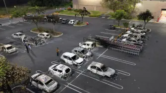 Aerial view of burned cars in the parking lot of a Costco retail store in Puerto Vallarta, Jalisco state, Mexico, on February 23, 2026. Mexico has deployed 10,000 troops to quell clashes sparked by the killing of the country's most wanted drug lord, which have left dozens dead, officials said on February 23. Nemesio 