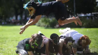 A person jumps over others while walking on all fours during a gathering of teenagers who identify as "Therians," a subculture whose members adopt animal characteristics, in Buenos Aires, Argentina, February 22, 2026. REUTERS/Tomas Cuesta