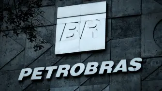 (FILES) A logo of Brazilian oil company Petrobras is seen at the entrance of its headquarters in Rio de Janeiro, Brazil, on July 15, 2016. Brazilian state-owned giant oil company Petrobras tripled its profits in 2025 compared to the previous year, driven by record oil and gas production, according to the company's annual results released on March 5, 2026. (Photo by YASUYOSHI CHIBA / AFP)