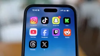 Instagram, TikTok, Snapchat, Kick, YouTube, Facebook, Twitch, Reddit, Threads and X applications are displayed on a mobile phone ahead of new law banning social media for users under 16 in Australia, in this picture illustration taken on December 9, 2025. REUTERS/Hollie Adams/Illustration