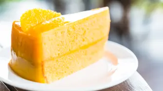 Orange cakes in white plate on wooden tables - selective focus shot