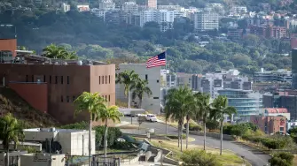 (FILES) The US flag flutters at the US embassy in Caracas on March 14, 2026, ten days after the restoration of diplomatic relations following the capture of ousted leader Nicolas Maduro in a US military raid. The US Embassy in Venezuela resumed operations on March 30, 2026, after being closed for seven years, the State Department announced, following Washington's ouster of leftist president Nicolas Maduro. Today, we are formally resuming operations at the US embassy in Caracas, marking a new chapter in our diplomatic presence in Venezuela,