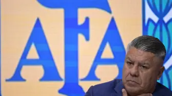 (FILES) The president of the Argentine Football Association (AFA), Claudio Tapia, looks on during a press conference in Ezeiza, Buenos Aires province, on March 18, 2025, announcing a training session open to the public between the national football team and the U20 team to be held on March 22 at the Tomas Adolfo Duco Stadium in Buenos Aires in support of the city of Bahia Blanca, hit by a storm that left 16 people dead. An Argentine judge has formally charged the Argentine Football Association (AFA), its president Claudio Chiqui Tapia and other officials with tax evasion, according to a ruling released on March 30, 2026. (Photo by JUAN MABROMATA / AFP)