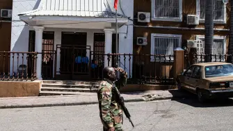 A soldier patrols in front of the Provisional Electoral Council (CEP) as the government announces the registration period for political parties ahead of the upcoming general election, in Port-au-Prince, Haiti, on March 3, 2026. Haiti's presidential transitional council, which has run the impoverished Caribbean nation for nearly two years, on February 7, 2026, handed power to US-backed Prime Minister Alix Didier Fils-Aime, after failing to rein in rampant gang violence. Rubio said in February he was upbeat about progress in setting up a new UN-blessed force to suppress Haiti's powerful gangs and voiced hope that the country will finally hold elections this year for the first time in a decade. (Photo by Clarens SIFFROY / AFP)