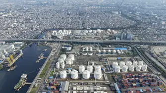 This aerial picture shows the oil depot and container terminal of Tanjung Priok Port, Jakarta, on March 31, 2026. (Photo by BAY ISMOYO / AFP)