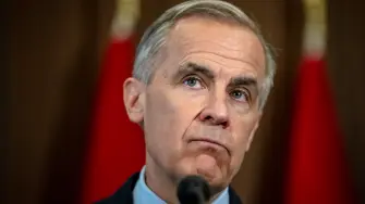 Canadian Prime Minister Mark Carney speaks during a press conference at the West Block on Parliament Hill in Ottawa, Ontario, Canada, on April 14, 2026. Carney's Liberal party secured a majority in Canada's parliament on April 13 after winning all three by-election seats up for grabs, boosting his Liberals as they work to bolster a country shaken by threats from the United States. (Photo by ANDREJ IVANOV / AFP)
