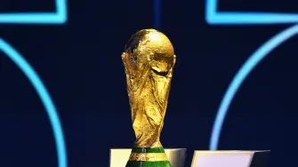The FIFA World Cup Trophy is displayed on a podium during the draw for the 2026 FIFA Football World Cup taking place in the US, Canada and Mexico, at the Kennedy Center, in Washington, DC, on December 5, 2025. (Photo by Mandel NGAN / POOL / AFP)