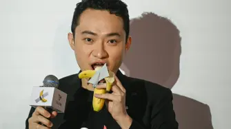 Chinese-born crypto founder Justin Sun eats a banana artwork composed of a fresh banana stuck to a wall with duct tape, in Hong Kong on November 29, 2024, after buying the provocative work of conceptual art by Italian artist Maurizio Cattelan at a New York auction for $6.2 million. The debut of the edible creation entitled "Comedian" at the Art Basel show in Miami Beach in 2019 sparked controversy and raised questions about whether it should be considered art -- Cattelan's stated aim. (Photo by Peter PARKS / AFP)