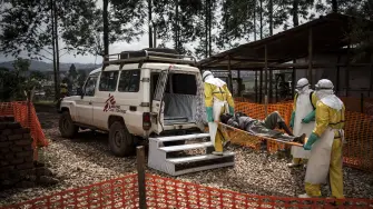 (FILES) Health workers move a patient to a hospital after he was cleared of having Ebola inside a MSF (Doctors Without Borders) supported Ebola Treatment Centre (ETC) on November 4, 2018 in Butembo, Democratic Republic of the Congo. An outbreak of the ebola virus has been blamed for dozens of deaths in the east of the Democratic Republic of the Congo, African health authorities said on May 15, 2026.The outbreak is in Ituri province. (Photo by John WESSELS / AFP)