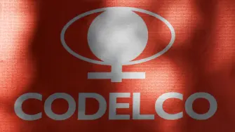 (FILES) The logo of the National Copper Corporation (CODELCO) is pictured on a sign with information about the remodeling of the facade of its building in Santiago on May 20, 2025. The Chilean state-owned company Codelco, the worlds largest copper producer, has launched an audit to investigate whether its copper production forecast for 2025 may have been overestimated, the company told AFP on May 13, 2026. (Photo by RODRIGO ARANGUA / AFP)
