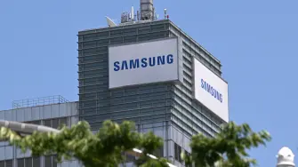 The logo of Samsung Electronics is seen on the top of a building at the company's headquarters in Suwon on May 22, 2026. Samsung labour union members will begin voting on May 22, on a tentative wage deal that could deliver hefty bonuses to chip workers and helped avert a major strike at the South Korean tech giant this week. (Photo by Jung Yeon-je / AFP)