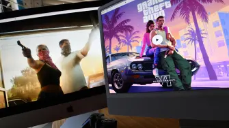 (FILES) This illustration photo created in Los Angeles, California, on December 5, 2023, shows Rockstar Games Grand Theft Auto 6 trailer played on computer screens. Thirteen years of waiting are about to come to an end: the video game "Grand Theft Auto VI," the latest installment in the saga from US studio Rockstar Games, opens for pre-orders on June 25, 2026, and is poised to become the biggest launch of a cultural product in history. (Photo by Chris DELMAS / AFP)