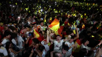 Spain's supporters celebrate victory at the end of the 2026 World Cup semi-final match between Spain and France on a giant screen in 'Madrid Rio' fan zone in Madrid on July 14, 2026. (Photo by Pierre-Philippe MARCOU / AFP)