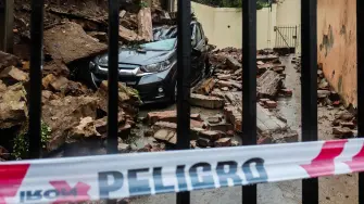 View of a car crushed by a wall that collapsed due to heavy storms in Viña del Mar, Valparaiso region, Chile, on July 17, 2026. Three people died and 76 were affected amid a storm with heavy rains, swells, and winds that is impacting 10 of the countrys 16 regions, the government reported. (Photo by Cristobal Basaure / AFP)