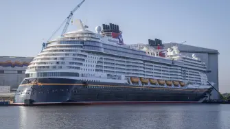 The new Disney Treasure cruise ship of Disney Cruise line is moored at the Meyer shipyards in Papenburg, northwestern Germany on September 16, 2024. At the company meeting, the employees were informed that the troubled luxury shipbuilder had been saved by the intervention of the Federal Republic of Germany and the state of Lower Saxony. (Photo by Focke STRANGMANN / AFP)
