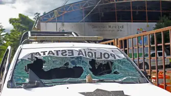 A destroyed police vehicle is seen after at least 12 Mexican soldiers and 15 police officers from the southern state of Guerrero were held by residents while conducting an operation against the Los Ardillos criminal group in the municipality of Quechultenango, Mexico, on September 17, 2026. (Photo by Eduardo GUERRERO / AFP)