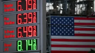 Gas prices at a Shell gas station above $6 a gallon for regular gasoline and $8 a gallon for diesel are displayed across from a US flag outside of the Marathon Petroleum Corp. Los Angeles Refinery in Carson, California on September 22, 2026. According to the companys website, the refinery is the largest on the West Coast with a crude oil capacity of 365,000 barrels per calendar day, producing California Air Resources Board (CARB) gasoline and CARB diesel fuel among other products. (Photo by Patrick T. Fallon / AFP)