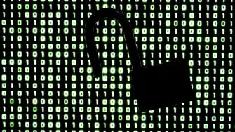 An illustration picture taken on October 21, 2026 shows a padlock in front of binary code on a laptop screen in Frankfurt am Main, western Germany. Government agencies and companies around the world shut down websites on October 21, 2026 after two critical flaws came to light involving PHP, a programming language that is the basis for a large share of the internet. (Photo by Kirill KUDRYAVTSEV / AFP)