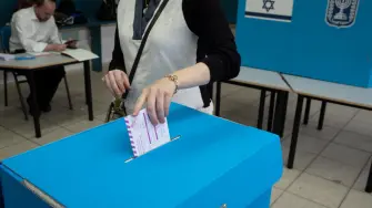 A woman casts her ballot at a polling station in Bnei Brak on October 27, 2026, during Israel's legislative election. A deeply divided Israel headed to the polls for the first time since Hamas's October 7, 2023 attack, with voters delivering their verdict on veteran prime minister and the country's rightward drift. (Photo by Maya Levin / AFP)