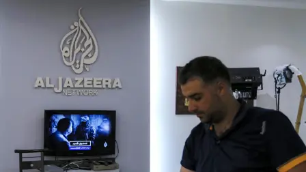 (FILES) An employee of the Qatar based news network and TV channel Al-Jazeera is seen at the channel's Jerusalem office on July 31, 2017. - The Palestinian Authority on January 1, 2025 ordered the suspension of broadcasts by the Qatar-based Al Jazeera across the Palestinian territories, accusing the network of airing "inciting content," official media reported. (Photo by AHMAD GHARABLI / AFP)