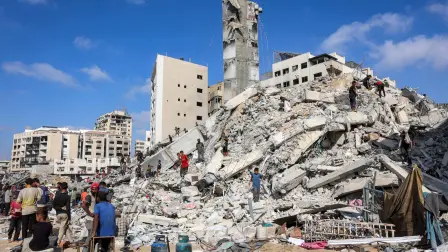 Personas buscan material de rescate en el montón de escombros donde se derrumbó la Torre Sussi.