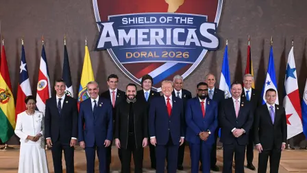 US President Donald Trump (C) stands with, (L/R), Trinidad and Tobago's Prime Minister Kamla Persad-Bissessar, Santiago Peña, President of the Republic of Paraguay, Luis Abinader, President of the Dominican Republic, Rodrigo Paz Pereira, President of Bolivia, Nayib Bukele, President of El Salvador, Javier Milei, President of Argentina, José Raúl Mulino, President of Panama, Mohamed Irfaan Ali, President of Guyana, Nasry Tito Asfura, President of Honduras, Rodrigo Chaves Robles, President of Costa Rica, José Antonio Kast, President-elect of Chile, and Daniel Roy Gilchrist Noboa Azín, President of Ecuador, during a group photograph at the start of the "Shield of the Americas" Summit at Trump National Doral in Miami, Florida, March 7, 2026. President Trump is hosting a dozen right-wing leaders from Latin America and the Caribbean to discuss issues facing the region, from organized crime to illegal immigration. The summit also aims to serve Washington by boosting US interests in the region and curbing those from foreign powers like China. (Photo by SAUL LOEB / AFP)