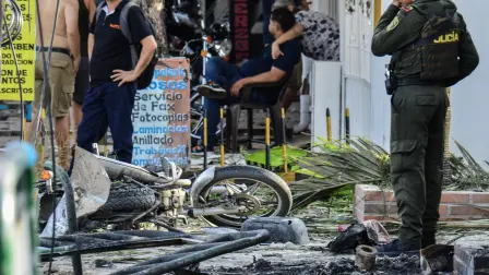 Un miembro de la Policía Nacional de Colombia inspecciona los escombros en el lugar de la explosión.