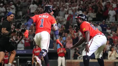 Oct 1, 2026; Cumberland, Georgia, USA;  Atlanta Braves infielder Ozzie Albies (1) celebrates with third base coach Tommy Watkins (84) after hitting a two-run home run against Philadelphia Phillies pitcher Zack Wheeler (not pictured) during the fourth inning in game three of the Wildcard round for the 2026 MLB Playoffs at Truist Field.  Mandatory Credit: Dale Zanine-Imagn Images