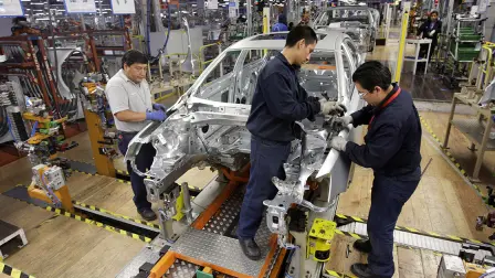 Employees work on the assembly line on the Jetta Bicentennial at the Volkswagen automobile manufacturing factory in Puebla - Employees work on the assembly line on the Jetta Bicentennial at the Volkswagen (VW) automobile manufacturing factory in Puebla August 12, 2010. Puebla, which will manufacture over half a million vehicles every year, is VW