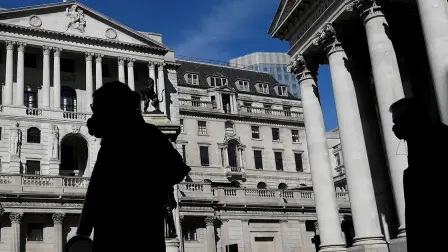 FILE PHOTO: People wearing masks walk past the Bank of England, as the spread of the coronavirus disease (COVID-19) continues, in London, Britain, March 23, 2020. REUTERS/Toby Melville/File Photo-NARCH/NARCH30
