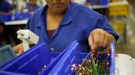An employee works at Ark de Mexico, an assembly factory that makes wire harnesses and electric components for the automobile industry, in Ciudad Juarez