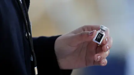 A medical worker holds a dose of the Pfizer-BioNTech COVID-19 vaccine at the Regional Military Specialty Hospital, in San Nicolas de los Garza