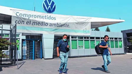 FILE PHOTO: Employees leave the Volkswagen (VW) plant as the company will temporarily close its factories in Mexico amid growing worries over the spread of the coronavirus disease (COVID-19), in Puebla