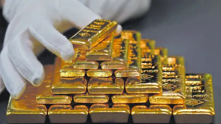 FILE PHOTO: An employee sorts gold bars in the Austrian Gold and Silver Separating Plant 