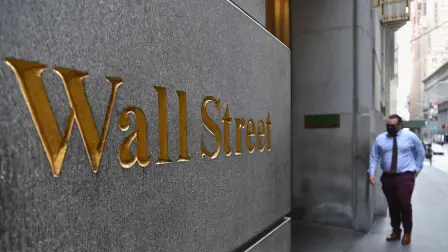 A man walks near the New York Stock Exchange (NYSE) on August 31, 2020 at Wall Street in New York City. - Wall Street stocks paused near record levels early Monday ahead of key economic data later in the week, with a newly-tweaked Dow index edging lower. The final session of a heady August opened on a lackluster note as markets await employment data and updates on the manufacturing and services sectors in the coming days. About 15 minutes into trading, the Dow Jones Industrial Average was down 0.4 percent to 28,539.83. (Photo by Angela Weiss / AFP)
