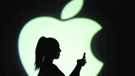 FILE PHOTO: Silhouette of mobile user is seen next to a screen projection of Apple logo in this picture illustration taken March 28, 2018.  REUTERS/Dado Ruvic/Illustration/File Photo-NARCH/NARCH30 NARCH/NARCH30