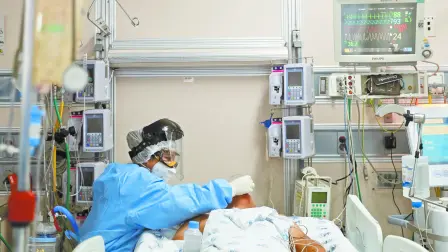 SENSITIVE MATERIAL. THIS IMAGE MAY OFFEND OR DISTURB    A medical worker in protective suit treats a patient suffering from the coronavirus disease (COVID-19) in an intensive care unit at Hospital Juarez de Mexico in Mexico City, Mexico October 29, 2020. REUTERS/Carlos Jasso-SMOUT