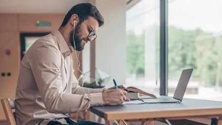 Young student with laptop indoors