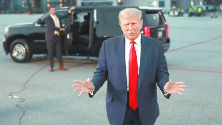 ATLANTA, GEORGIA - AUGUST 24: Former U.S. President Donald Trump speaks to the media at Atlanta Hartsfield-Jackson International Airport after surrendering at the Fulton County jail on August 24, 2023 in Atlanta, Georgia. Trump was booked on multiple charges related to an alleged plan to overturn the results of the 2020 presidential election in Georgia.   Joe Raedle/Getty Images/AFP (Photo by JOE RAEDLE / GETTY IMAGES NORTH AMERICA / Getty Images via AFP)