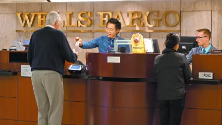 FILE PHOTO: Tellers serve customers at the Wells Fargo & Co. bank in downtown Denver