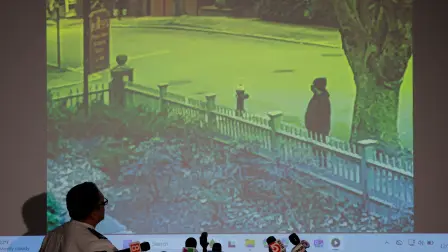 Providence Police Chief Colonel Oscar Perez looks at a new video released of the possible shooter at Brown University, during a press conference in Providence, Rhode Island, U.S., December 15, 2025.   REUTERS/Brian Snyder