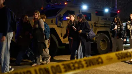 Evacuated Brown University students arrive at a temporary family reunification site at Nelson Fitness Center at Brown University in Providence, Rhode Island, on December 13, 2025. Hundreds of police officers hunted Sunday for a gunman who killed two people and wounded nine others at Brown University, plunging the eastern US campus into lockdown. (Photo by Bing Guan / AFP)