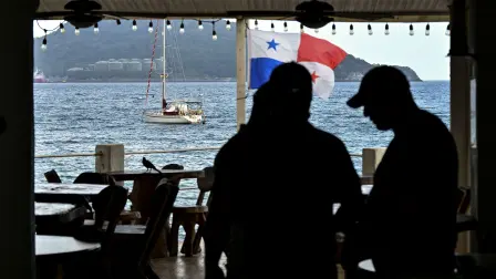Silhouette of tourists enjoying Taboga Island, located on the Pacific side in the Gulf of Panama and 20 km from Panama City, on December 30, 2025 (Photo by MARTIN BERNETTI / AFP)