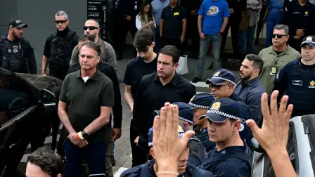 Former Brazilian President (2019-2022) Jair Bolsonaro (C) leaves the DF Star hospital accompanied by his son Jair Renan (C right, back) in Brasilia on September 14, 2025, after undergoing a series of medical examinations, as he remains under house arrest. Brazil's Supreme Court on September 11 sentenced firebrand ex-president Jair Bolsonaro to 27 years in prison for coup plotting at the end of a landmark trial that divided the nation and drew US fury. (Photo by Pablo PORCIUNCULA / AFP)