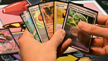 A player holds Pokémon TCG (Trading Cards Game) cards as they compete during the second day of the 2025 Pokémon World Championships at the Anaheim Convention Center Arena in Anaheim, California, on August 16, 2025. The 2025 Pokémon World Championships bring together players from around the globe for three days of competition, concluding with the Championship Finals on Sunday, August 17. (Photo by Frederic J. BROWN / AFP)