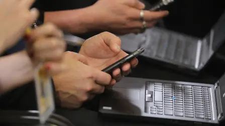 Journalists work with their cell phones and laptop during a press conference on December 14, 2018 in Brussels on the second day of a European Summit aimed at discussing the Brexit deal, the long-term budget and the single market. (Photo by Ludovic MARIN / AFP)
