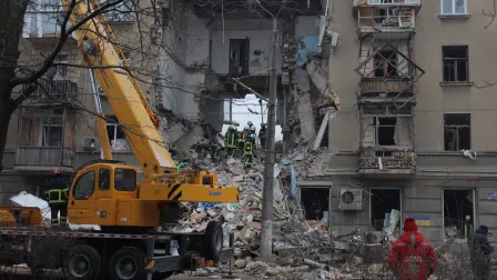 Ukrainian rescuers work among the rubble of a heavily damaged residential building following an air attack in Odesa on January 27, 2026, amid the Russian invasion of Ukraine. (Photo by Oleksandr GIMANOV / AFP)