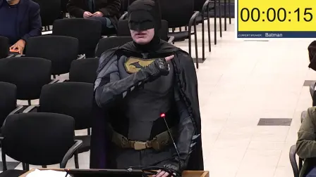 This frame grab from a January 27, 2026, video from a City of Santa Clara, California city council meeting shows a man dressed as Batman berating officials in the city set to host the Super Bowl in February over claims they could let ICE officers patrol the NFL final. The outburst came with tensions running high in the United States over the deaths this month of two protesters in Minneapolis, both shot dead by federal agents in operations run by Border Patrol and Immigration and Customs Enforcement (ICE). (Photo by HANDOUT / City of Santa Clara / AFP) / RESTRICTED TO EDITORIAL USE - MANDATORY CREDIT "AFP PHOTO /  CITY OF SANTA CLARA"- HANDOUT - NO MARKETING NO ADVERTISING CAMPAIGNS - DISTRIBUTED AS A SERVICE TO CLIENTS
