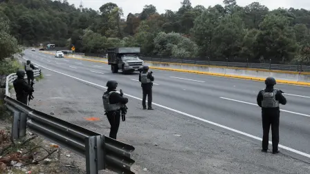 Members of the National Guard man a checkpoint on the highway connecting Mexico City with the state of Puebla, following roadblocks and arson attacks carried out by members of organized crime in several states after a military operation in which a government source said Mexican drug lord Nemesio Oseguera, known as “El Mencho,” was killed in Jalisco state, in Santa Rita Tlahuapan, Mexico, February 22, 2026. REUTERS/Paola Garcia